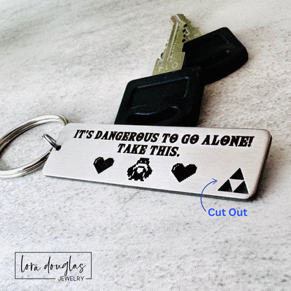 Minimalist engraved gamer keychain with brushed stainless steel finish and permanent engraving shown as personalized gaming accessory.