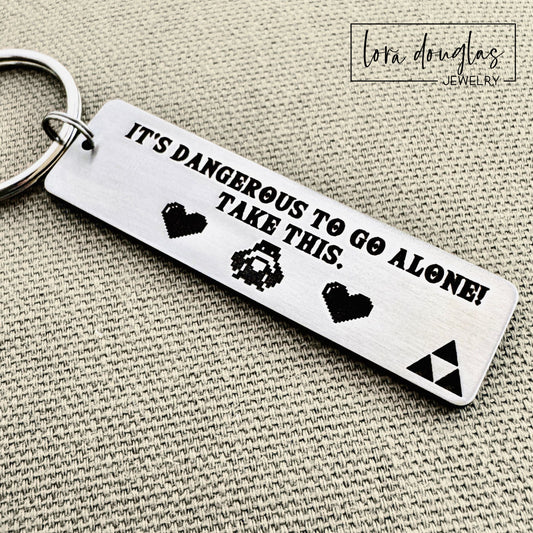 Engraved stainless steel gamer keychain featuring Triforce inspired cutout design and custom engraved message displayed with keys, designed as personalized video game fan gift.