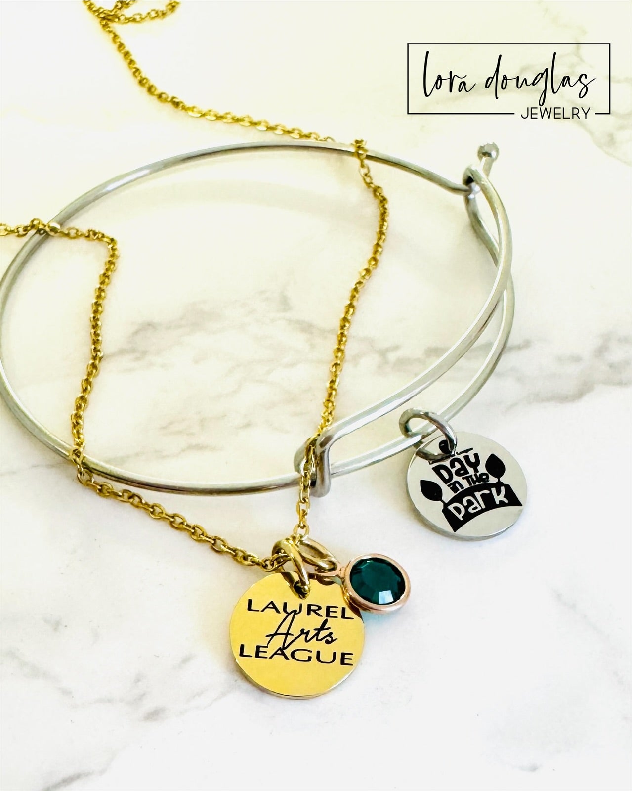 gold laurel arts league necklace with green gemstone pendant