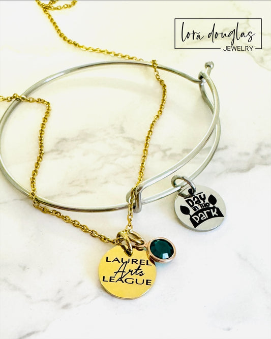 gold laurel arts league necklace with green gemstone pendant