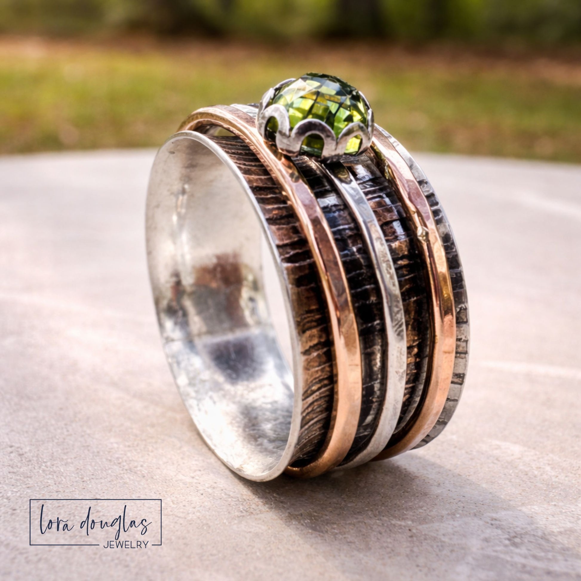 handcrafted silver and gold spinner ring with gemstone detail