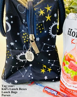 Backpack with star and moon pattern next to a juice box and snack package.