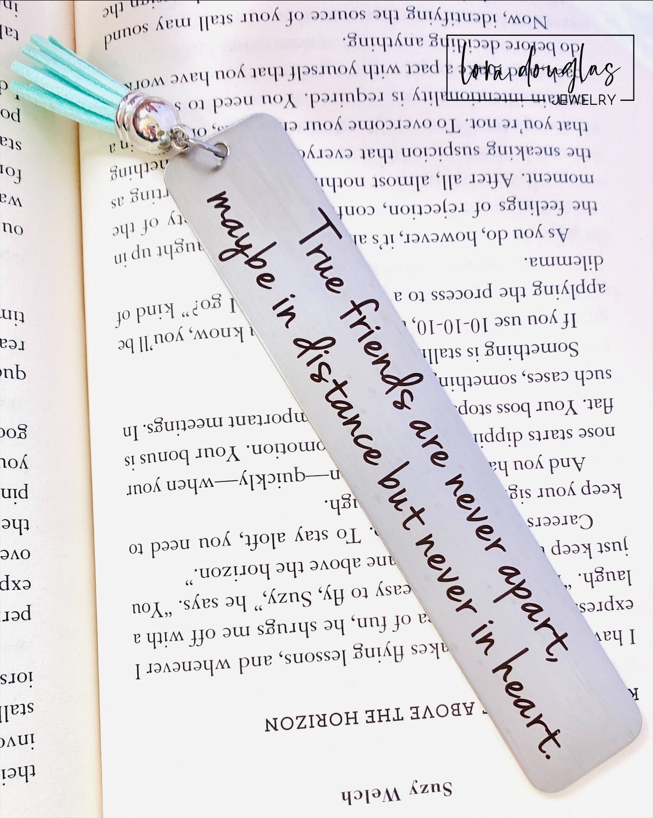 personalized long distance friendship bookmark displayed beside books and tassel, engraved stainless steel bookmark gift with heartfelt friendship quote and optional custom back engraving