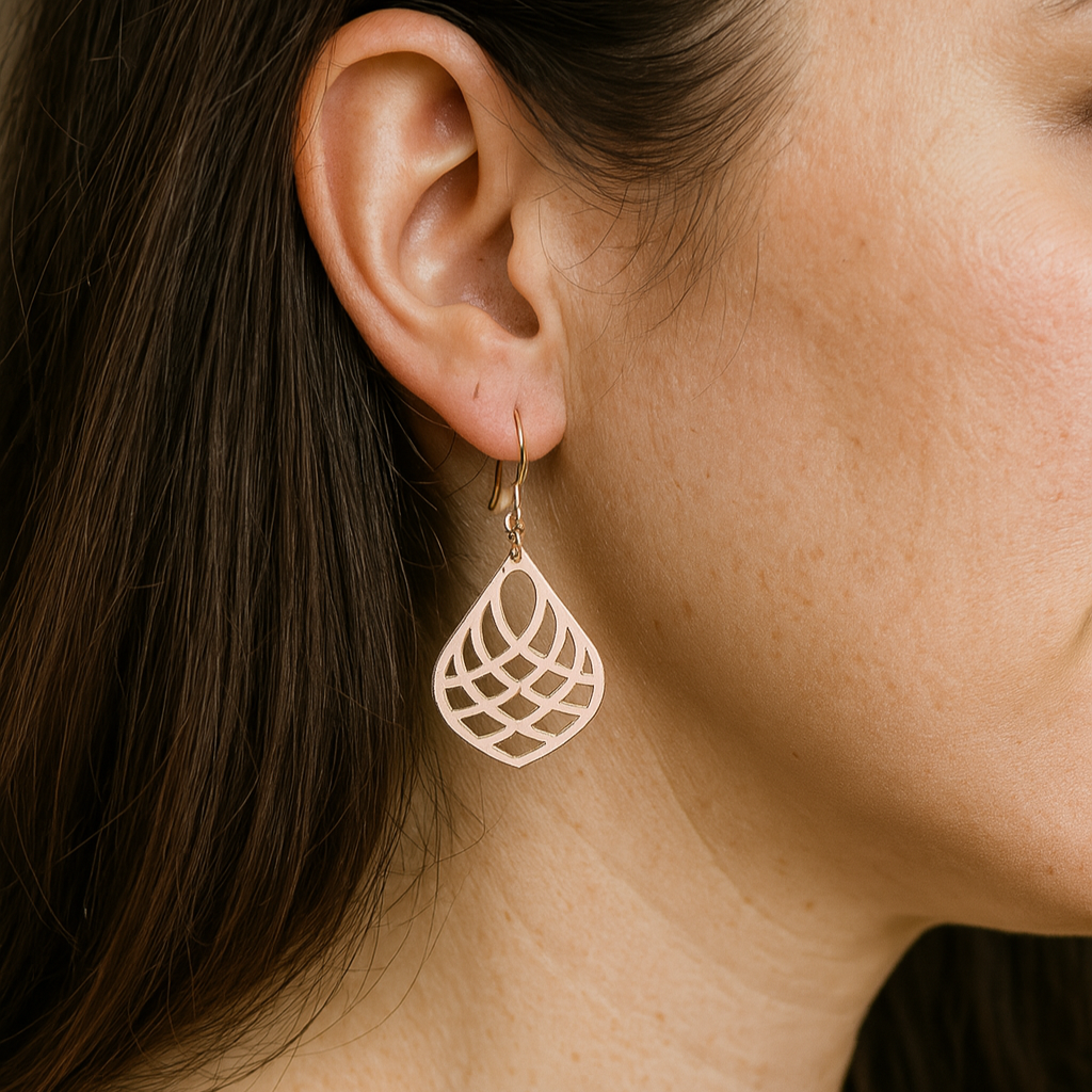 Side profile view of the silver earring hanging from an ear, emphasizing its length and elegant silhouette