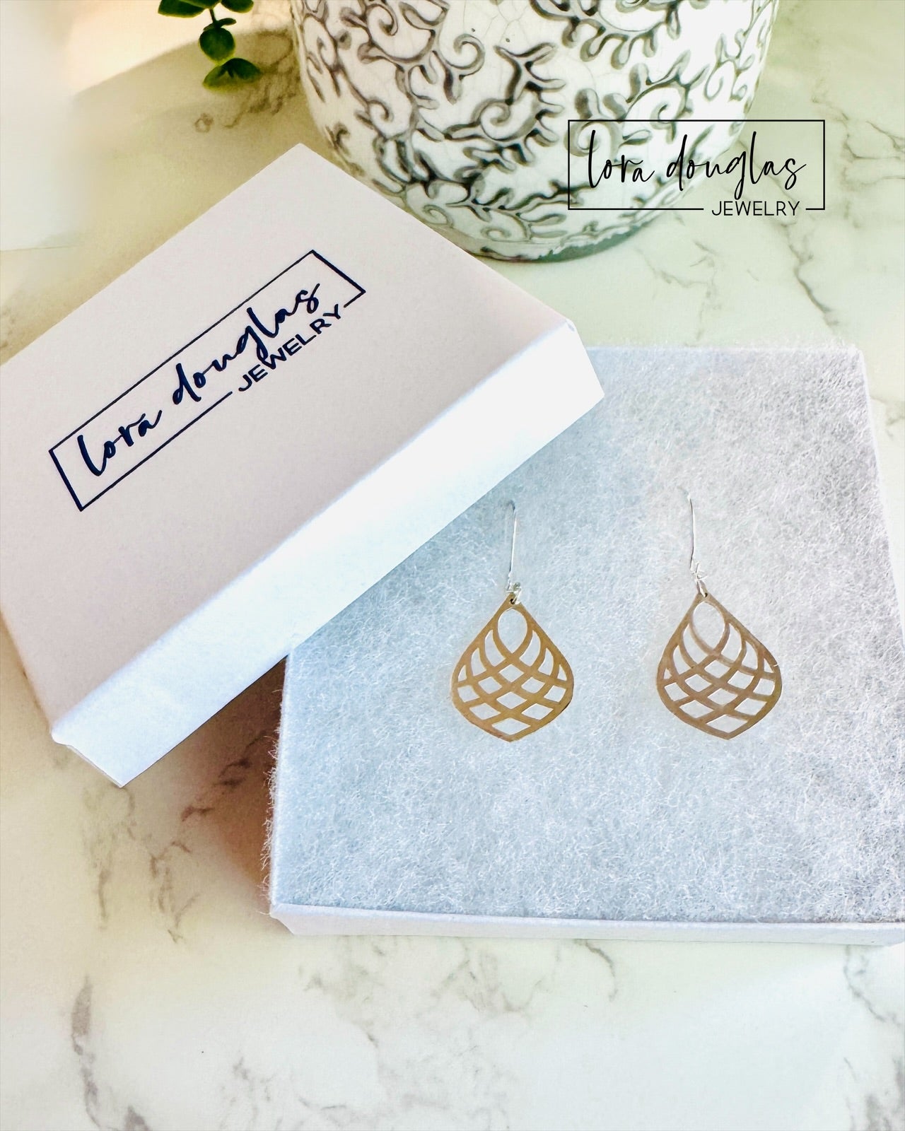 silver leaf-shaped earrings in Lora Douglas Jewelry branded box