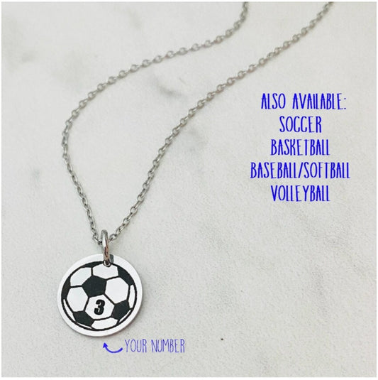 Necklace with a soccer ball pendant personalized with a jersey number on a light gray background