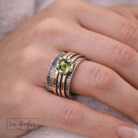 sterling silver spinner ring with peridot wide band mixed metal ring