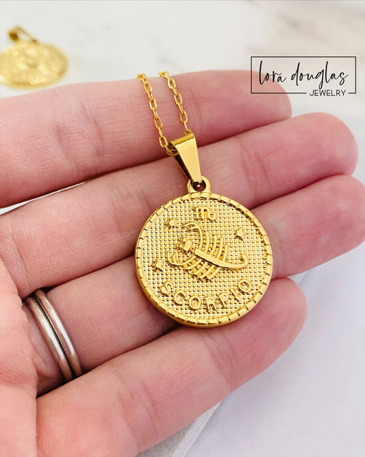 Close up of a gold stainless steel Constellation Necklace with engraved zodiac constellation pendant. Celestial jewelry featuring a polished finish and 24 inch chain, perfect for astrology lovers and horoscope gifts.