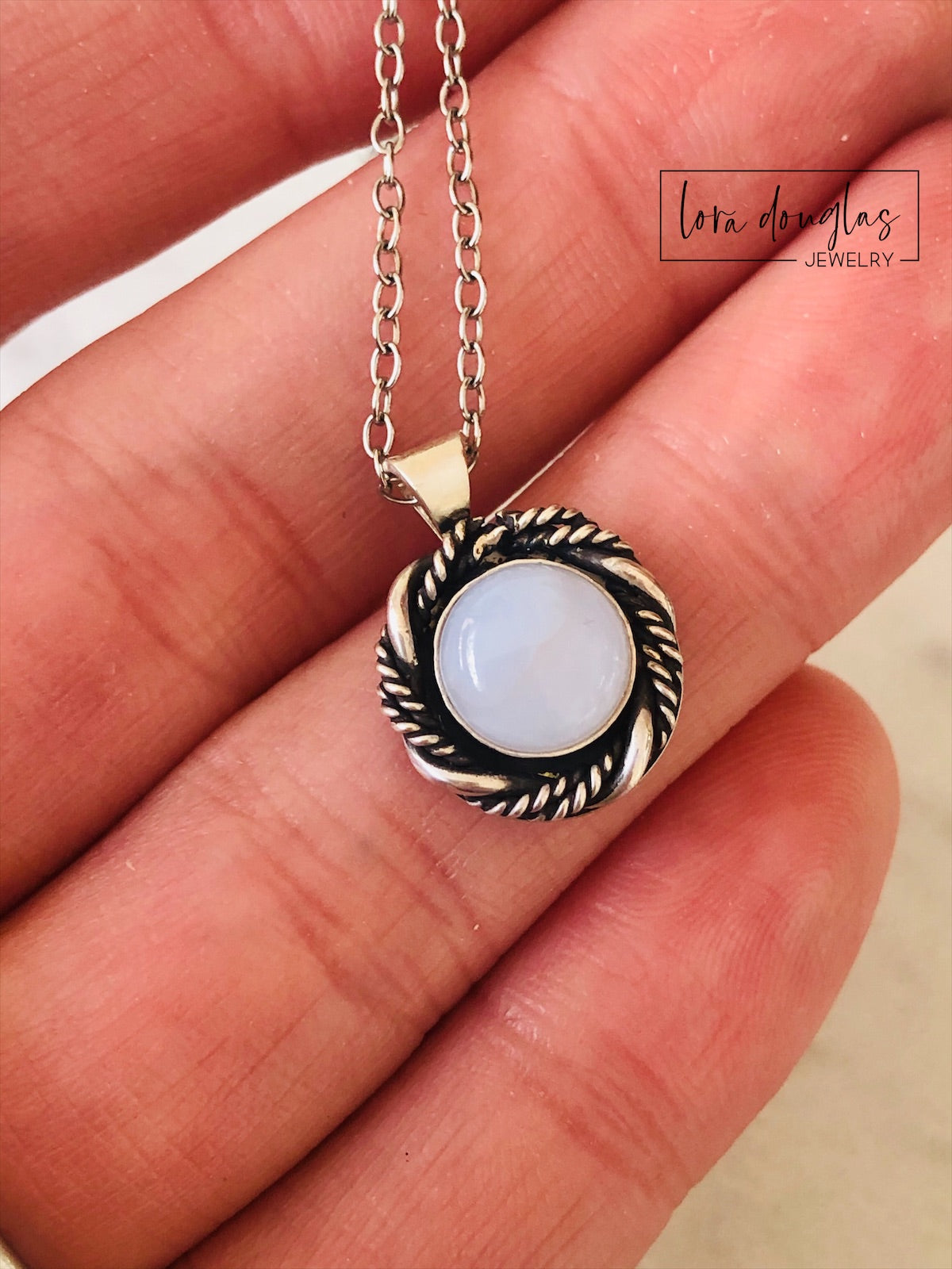 Close view of a chalcedony sterling silver pendant highlighting the natural 8mm gemstone and silver setting, a petite gemstone necklace designed for shoppers who prefer understated natural stone jewelry.

