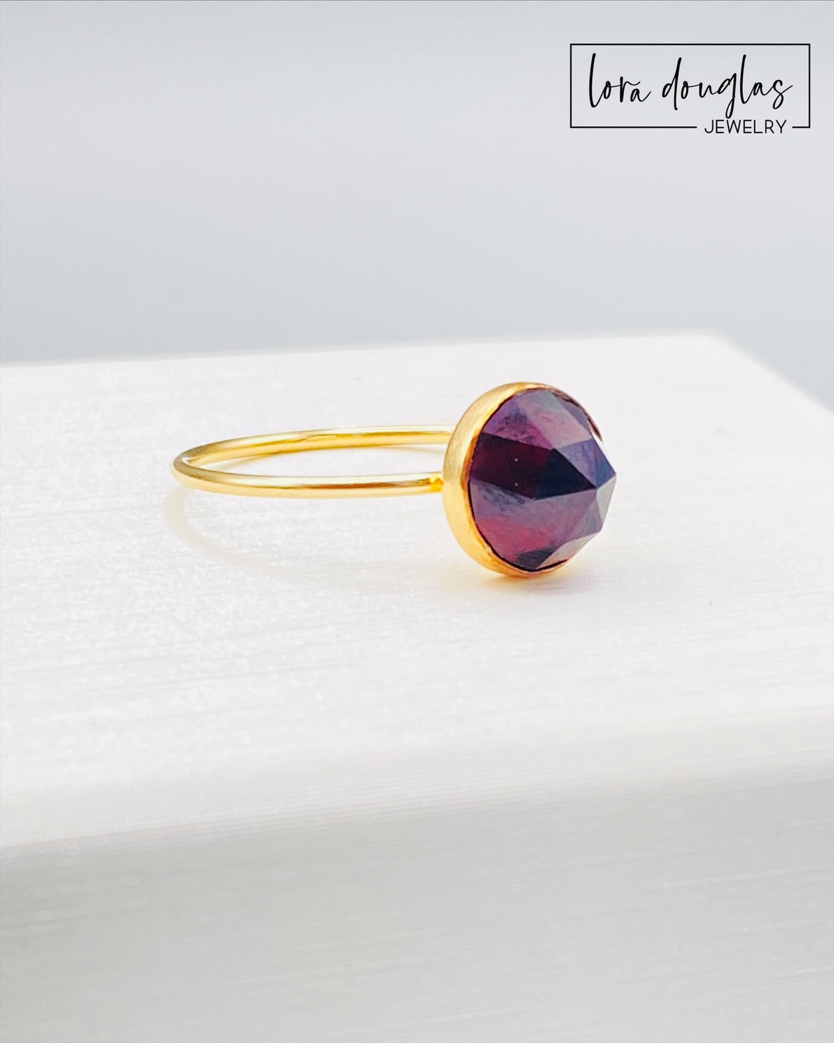 Close view of a rose cut garnet gemstone ring showing the faceted 8mm stone and warm 14/20 gold filled setting, a finished size 7 ring for shoppers seeking garnet jewelry or January birthstone gifts.
