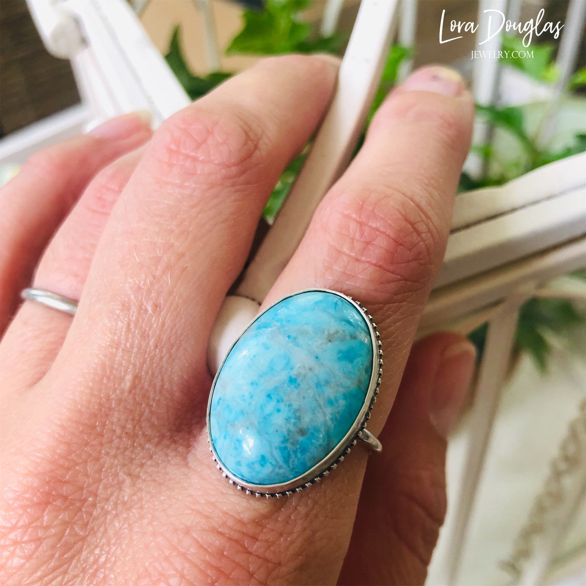 Detailed view of a 26mm x 19mm natural turquoise gemstone set in sterling silver, showing the distinctive blue color and natural character of this finished size 7 statement ring for turquoise collectors.
