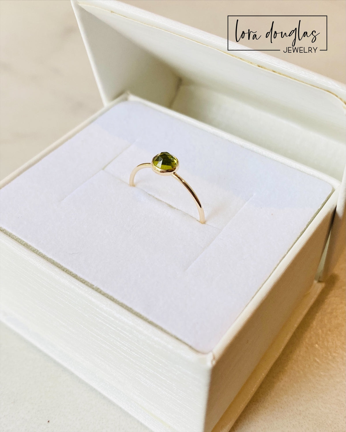 Detailed view of a natural peridot solitaire ring with a 5mm rose cut green gemstone and 14/20 gold filled setting, showing the clean design and faceted stone of this US size 6 ring.

