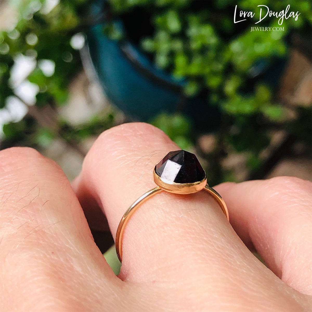 Detailed view of an 8mm rose cut garnet ring in 14/20 gold filled, showing the faceted gemstone surface and simple setting of this finished US size 7 ring for garnet lovers and January birthdays.
