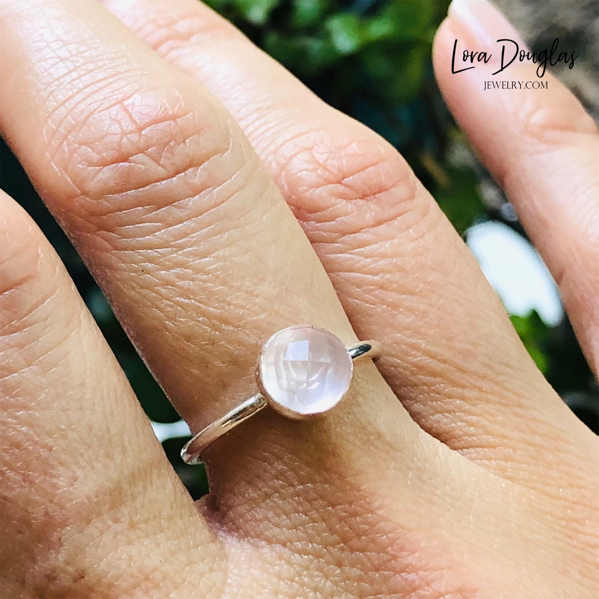Detailed view of an 8mm rose cut rose quartz gemstone set in sterling silver, highlighting the faceted surface and soft pink color of this finished size 7.5 solitaire ring for natural gemstone jewelry lovers.
