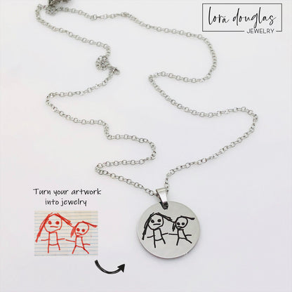 Engraved kids art charm created from an uploaded child's drawing and permanently laser engraved onto a polished stainless steel disc, a personalized artwork keepsake for parents, grandparents, and family members.