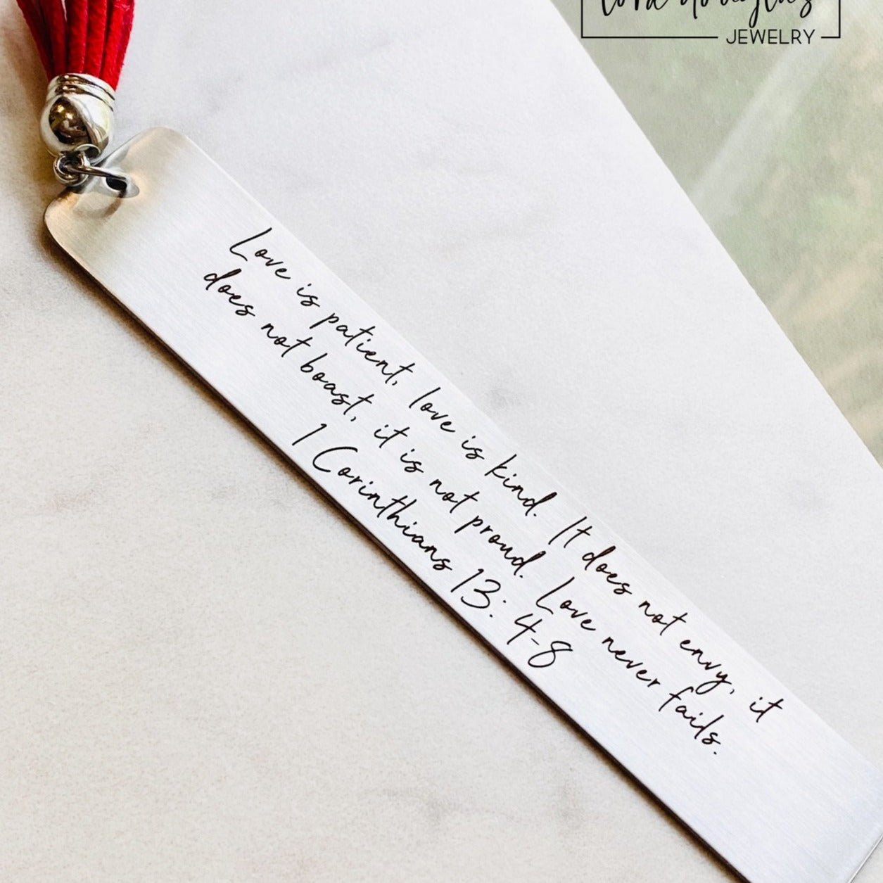 Engraved stainless steel bookmark featuring the 1 Corinthians 13 scripture "Love is patient, love is kind" with a colorful tassel. Thoughtful Christian bookmark gift for weddings, anniversaries, Bible study, pastors, church friends, and anyone who loves God's Word.