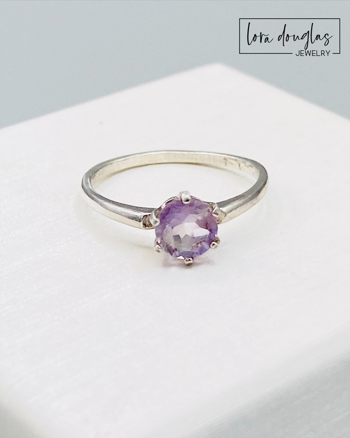 February birthstone ring featuring a 6mm pink amethyst gemstone in a sterling silver solitaire setting, finished in US size 6.5 for a February birthday, sixth anniversary or meaningful jewelry gift.
