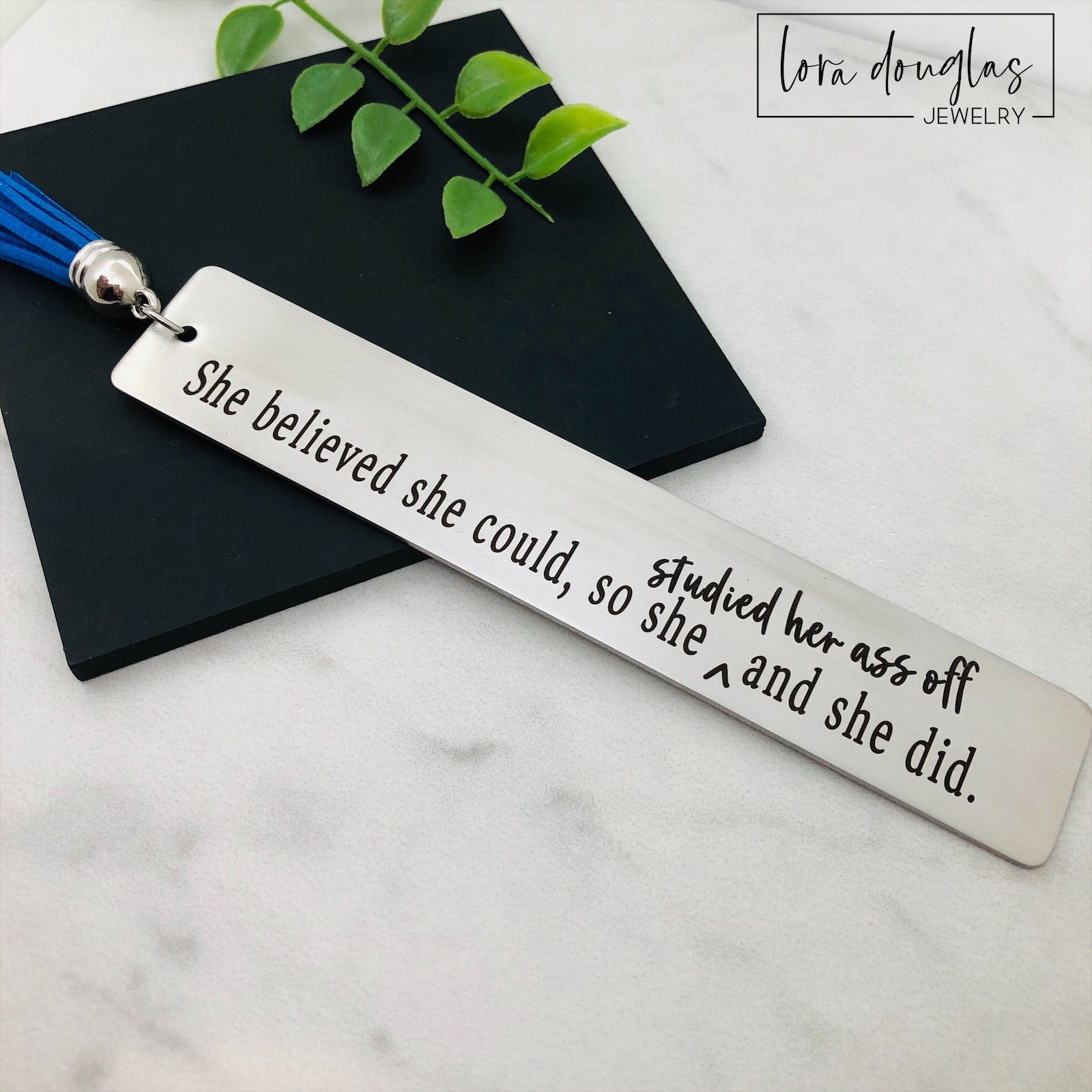 Funny stainless steel bookmark engraved with the quote "She Believed She Could So Studied Her Ass Off And She Did." Motivational gift for graduates, college students, nursing students, law students, medical students, and book lovers.