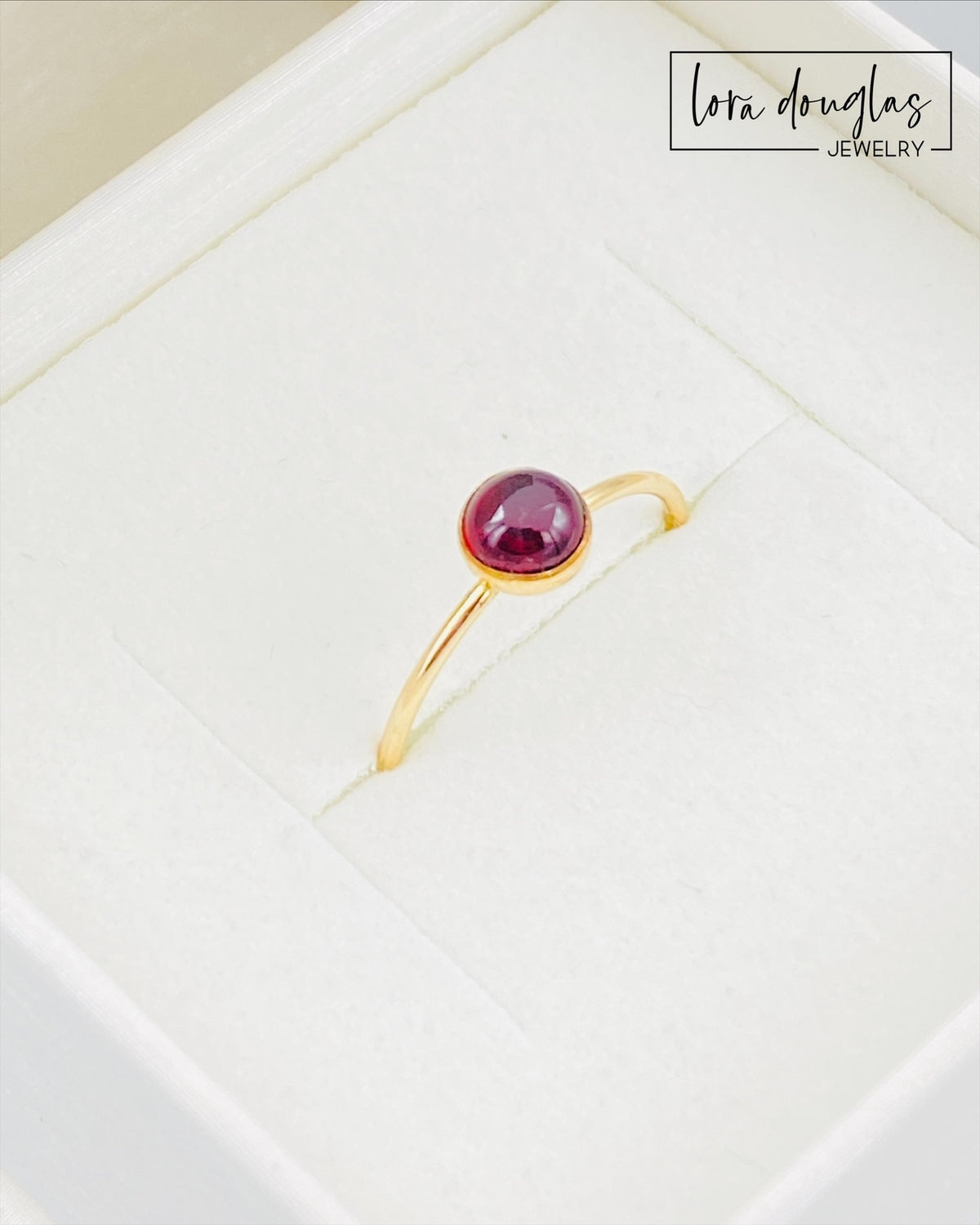Garnet solitaire ring shown with its 5mm red gemstone and 14/20 gold filled setting, a finished US size 6 ring traditionally associated with January birthdays, second anniversaries, love and devotion.