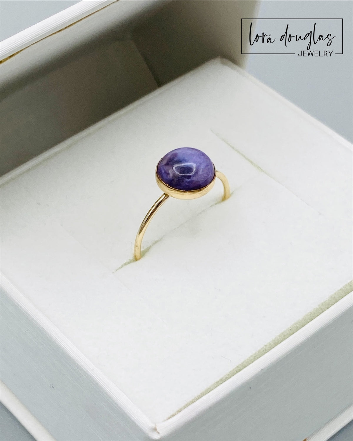 Gold filled charoite ring featuring a natural 8mm purple gemstone, with the richly colored stone as the focal point of this finished size 6 ring for lovers of charoite jewelry and unusual gemstones.
