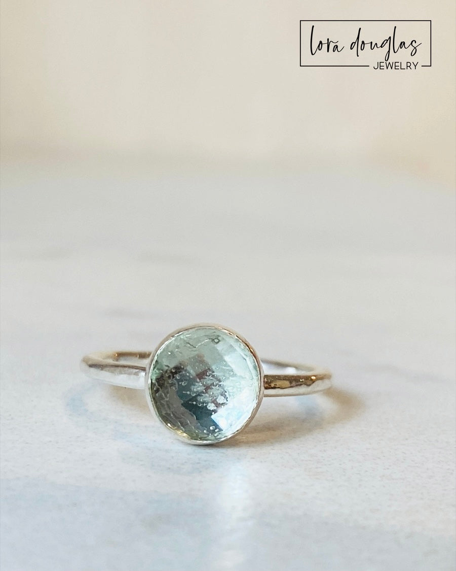 Green gemstone ring featuring an 8mm rose cut prasiolite stone in a sterling silver solitaire setting, shown in US size 6 for shoppers seeking understated natural stone jewelry with distinctive soft green color.
