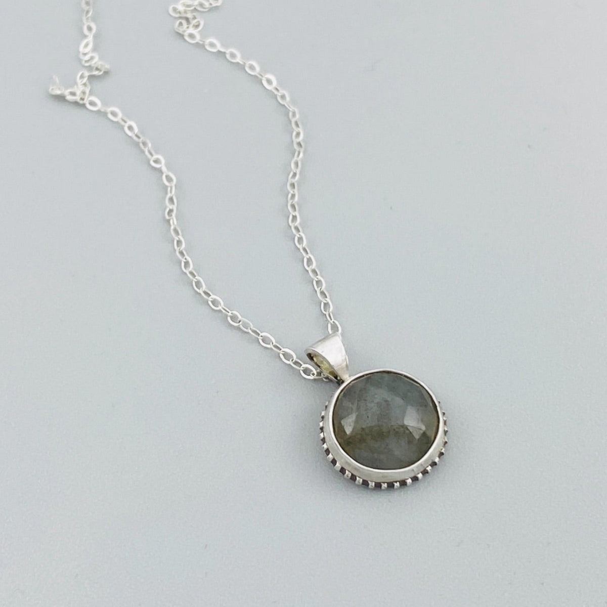 Handcrafted labradorite sterling silver necklace featuring a petite 1/2 inch natural gemstone pendant on an 18 inch silver chain, creating understated artisan jewelry for everyday wear or a unique gift for her.