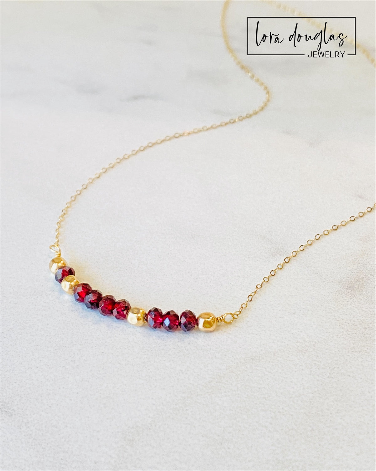 January birthstone necklace featuring faceted garnet and 14k gold filled beads arranged with the secret 143 meaning for I Love You, combining birthstone jewelry with a subtle romantic message in an 18 inch necklace.
