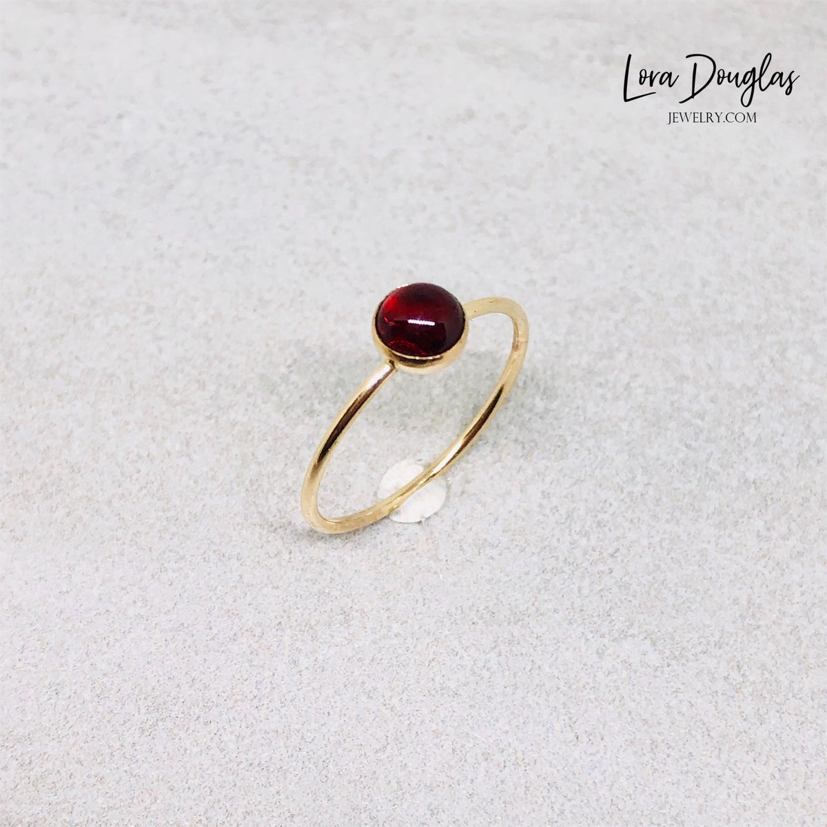 January birthstone ring featuring a 5mm garnet gemstone in a classic 14/20 gold filled solitaire setting, finished in US size 6 for a January birthday, second anniversary or meaningful jewelry gift.
