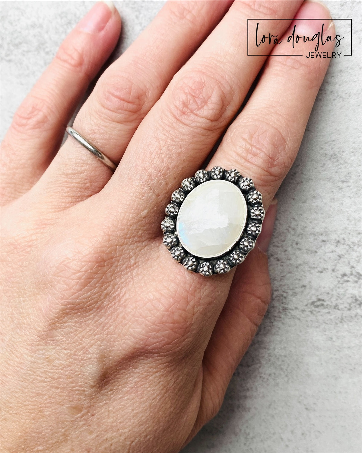 Large moonstone cocktail ring handcrafted from sterling silver in a US size 9. The 17 x 20 mm natural gemstone and substantial silver setting create a bold artisan ring for lovers of distinctive gemstone jewelry.