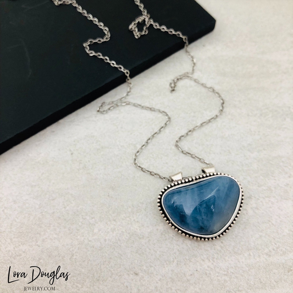 March birthstone necklace featuring natural aquamarine in a 20mm x 23mm sterling silver pendant, paired with an 18 inch antique patina chain for a birthday gift or meaningful gemstone jewelry.
