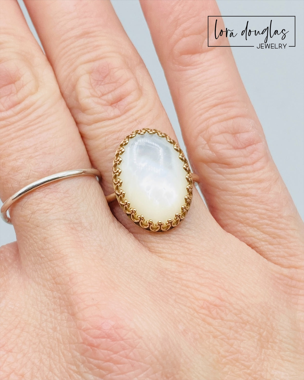 Natural Mother of Pearl jewelry featuring an iridescent shell stone in a warm bronze ring setting. Finished in a US size 6, this distinctive statement ring is a unique gift for women who love natural materials.