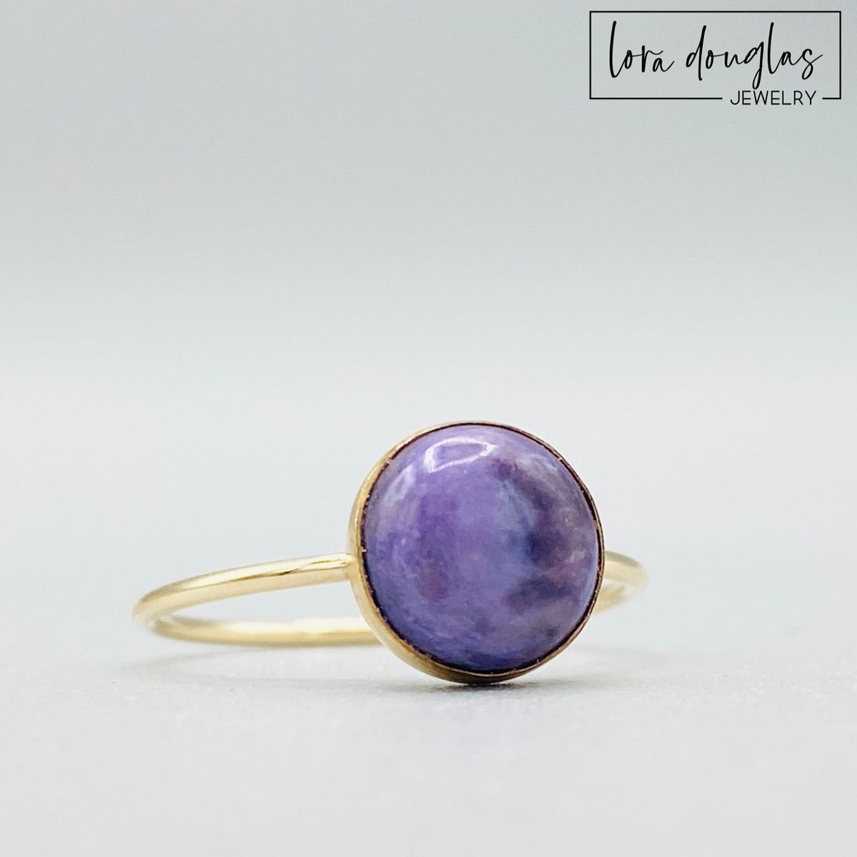 Natural charoite ring featuring an 8mm purple gemstone set in warm 14/20 gold filled, shown as a finished US size 6 ring for shoppers looking for distinctive purple gemstone and natural stone jewelry.
