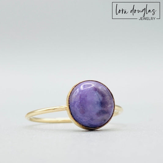 Natural charoite ring featuring an 8mm purple gemstone set in warm 14/20 gold filled, shown as a finished US size 6 ring for shoppers looking for distinctive purple gemstone and natural stone jewelry.
