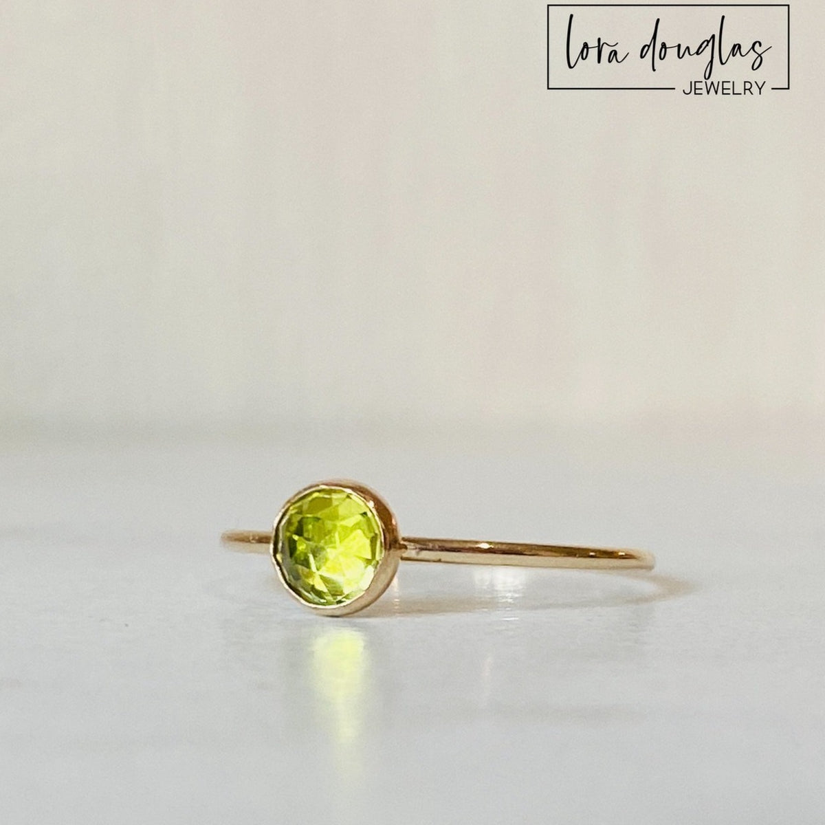 Natural green peridot ring featuring a 5mm rose cut faceted gemstone in a 14/20 gold filled solitaire setting, shown as a finished US size 6 ring for an August birthstone gift.
