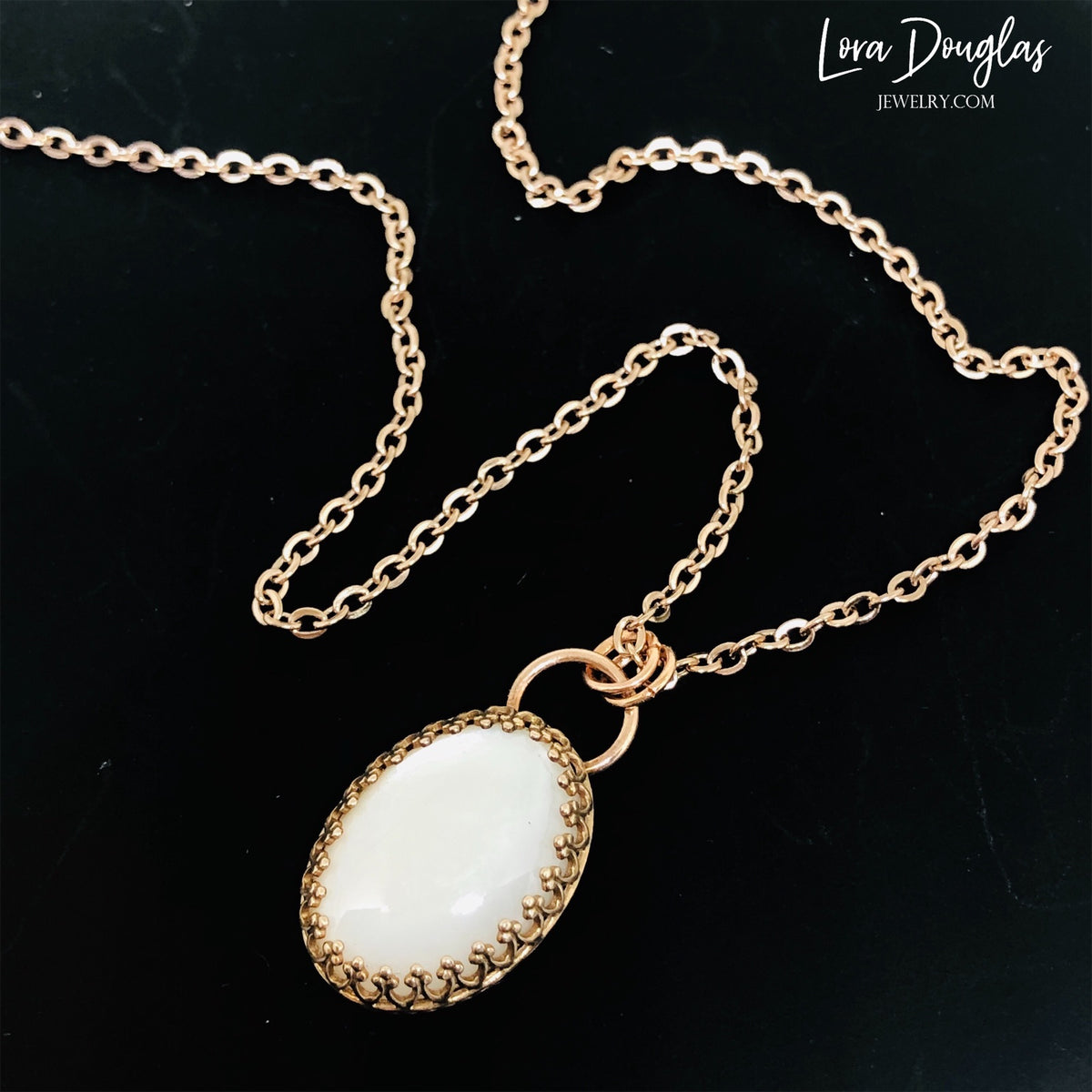Natural moonstone jewelry featuring a 24mm by 14mm bronze pendant on an 18 inch stainless steel chain with lobster clasp. A versatile gemstone necklace with warm neutral tones and a mixed metal design.