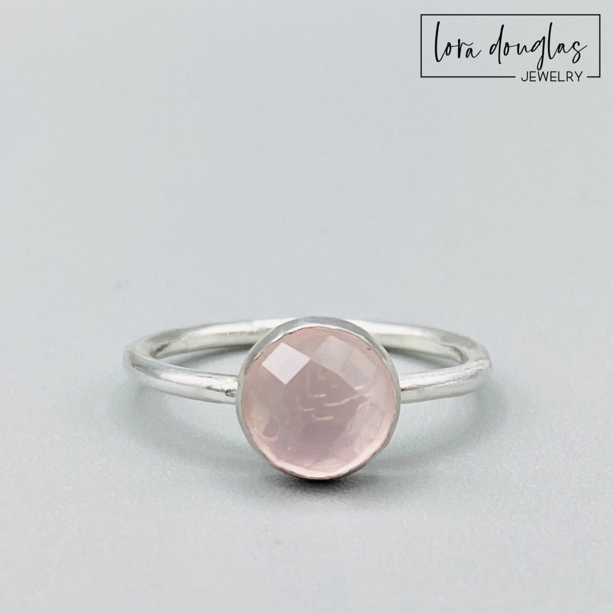 Natural rose quartz ring featuring an 8mm rose cut faceted pink gemstone set in sterling silver, shown as a finished US size 7.5 solitaire ring for shoppers looking for meaningful natural stone jewelry.
