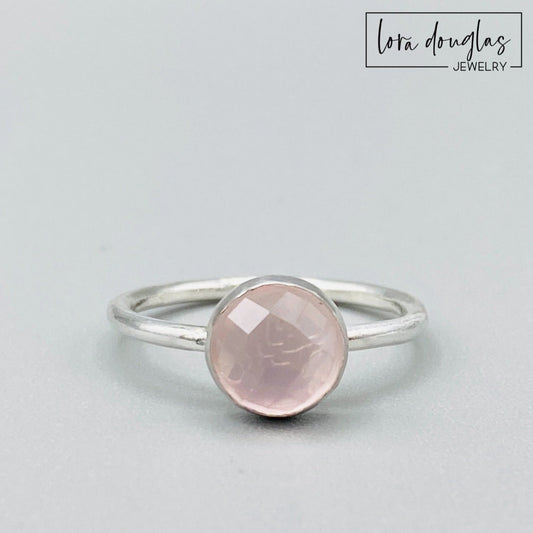 Natural rose quartz ring featuring an 8mm rose cut faceted pink gemstone set in sterling silver, shown as a finished US size 7.5 solitaire ring for shoppers looking for meaningful natural stone jewelry.
