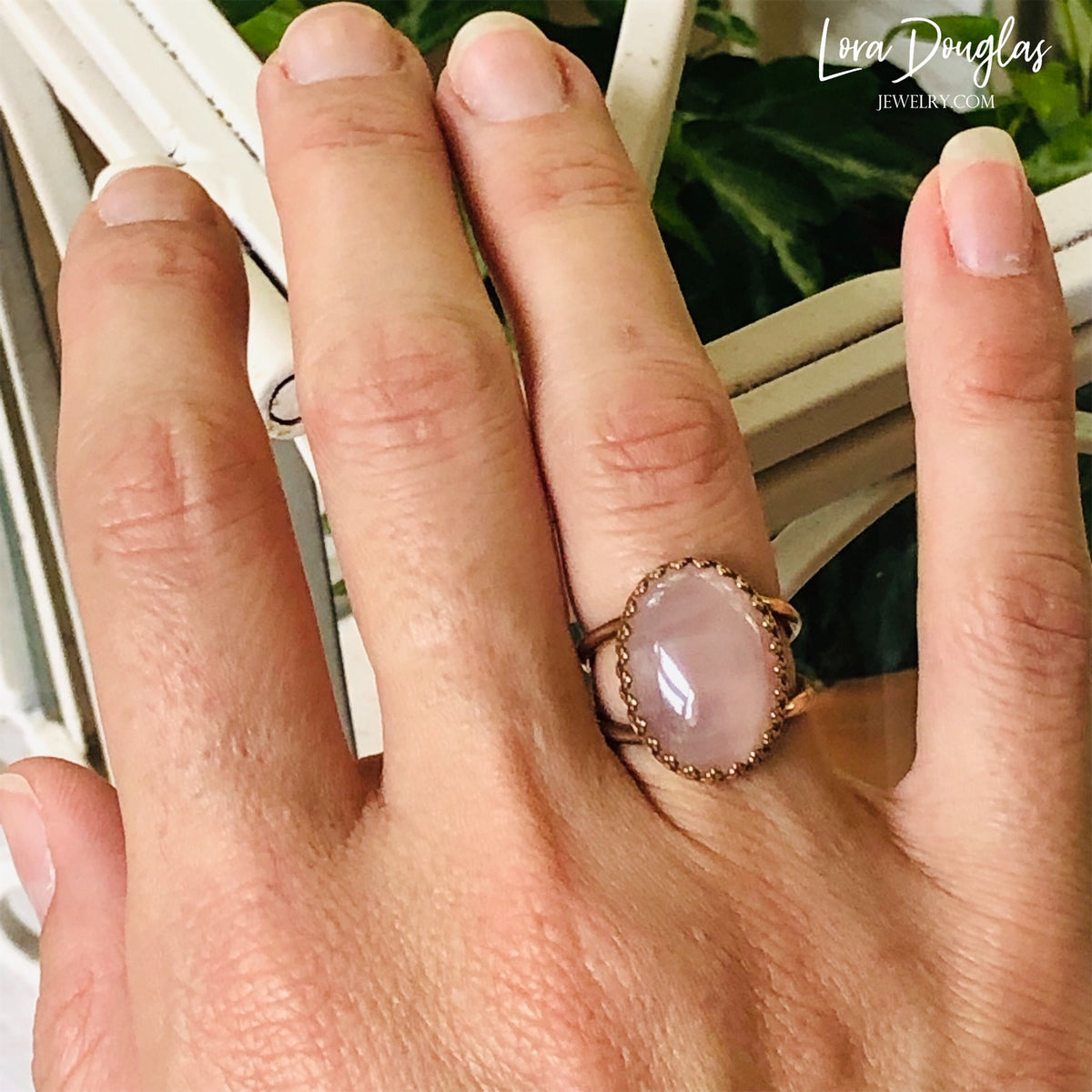 Natural stone ring featuring a large rose quartz gemstone set in warm bronze, highlighting the soft pink coloring and 18mm x 13mm stone of this finished size 6 ring for rose quartz jewelry lovers.
