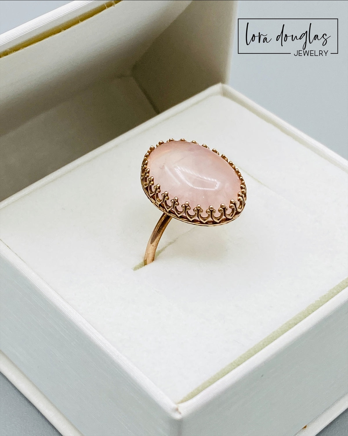 Natural stone ring featuring a large rose quartz gemstone set in warm bronze, highlighting the soft pink coloring and 18mm x 13mm stone of this finished size 7.5 ring for rose quartz jewelry lovers.
