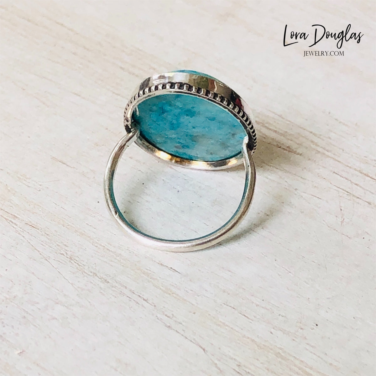Natural turquoise and sterling silver ring featuring a large 26mm x 19mm gemstone, highlighting the distinctive blue stone and classic silver setting of this finished US size 7 statement ring.
