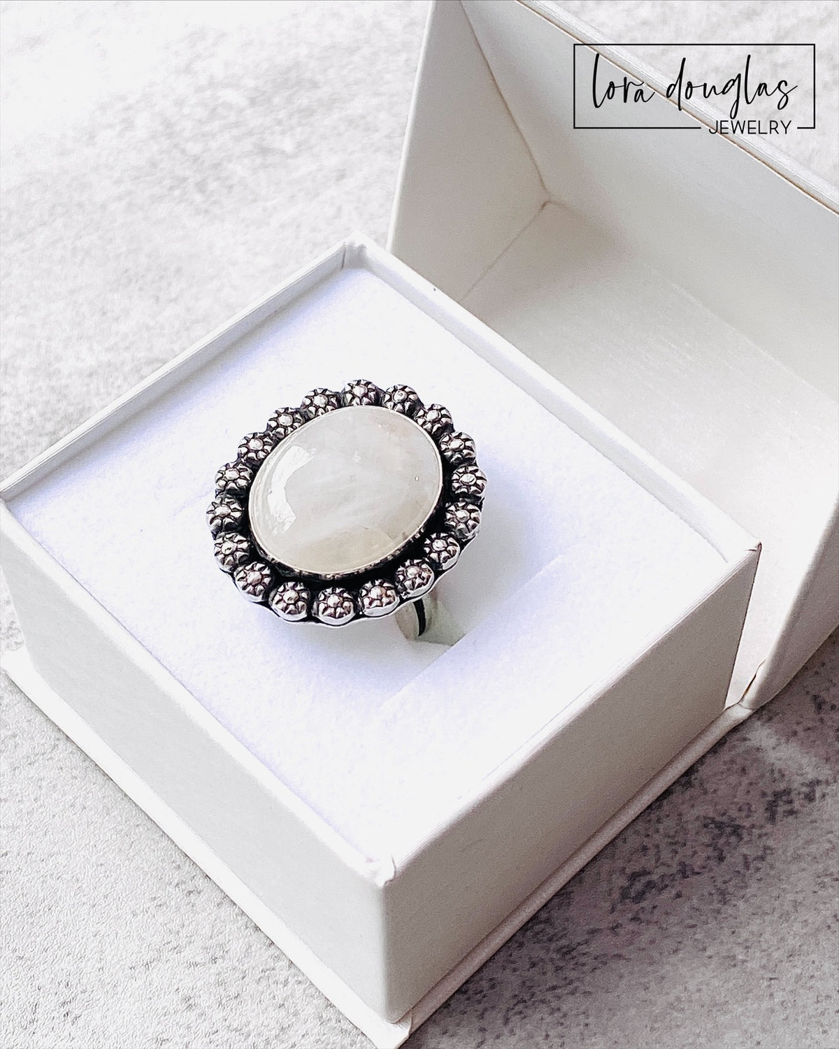 One of a kind moonstone statement ring with a natural 17 x 20 mm gemstone set in sterling silver. This handcrafted size 9 ring combines a large stone with a classic silver setting for a distinctive artisan look.