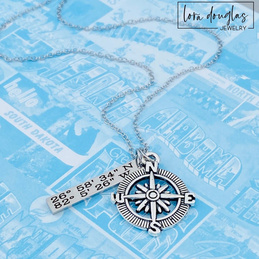 Personalized Coordinates Compass Necklace featuring a stainless steel compass charm and custom latitude longitude bar pendant engraved with GPS coordinates. Meaningful keepsake jewelry celebrating weddings, anniversaries, hometowns, travel memories, and special places.