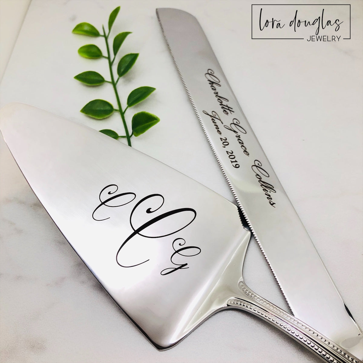 Personalized engraved cake knife shown with matching cake server, designed for parents or grandparents to give as a first birthday keepsake that can be used for birthday cakes every year as the child grows