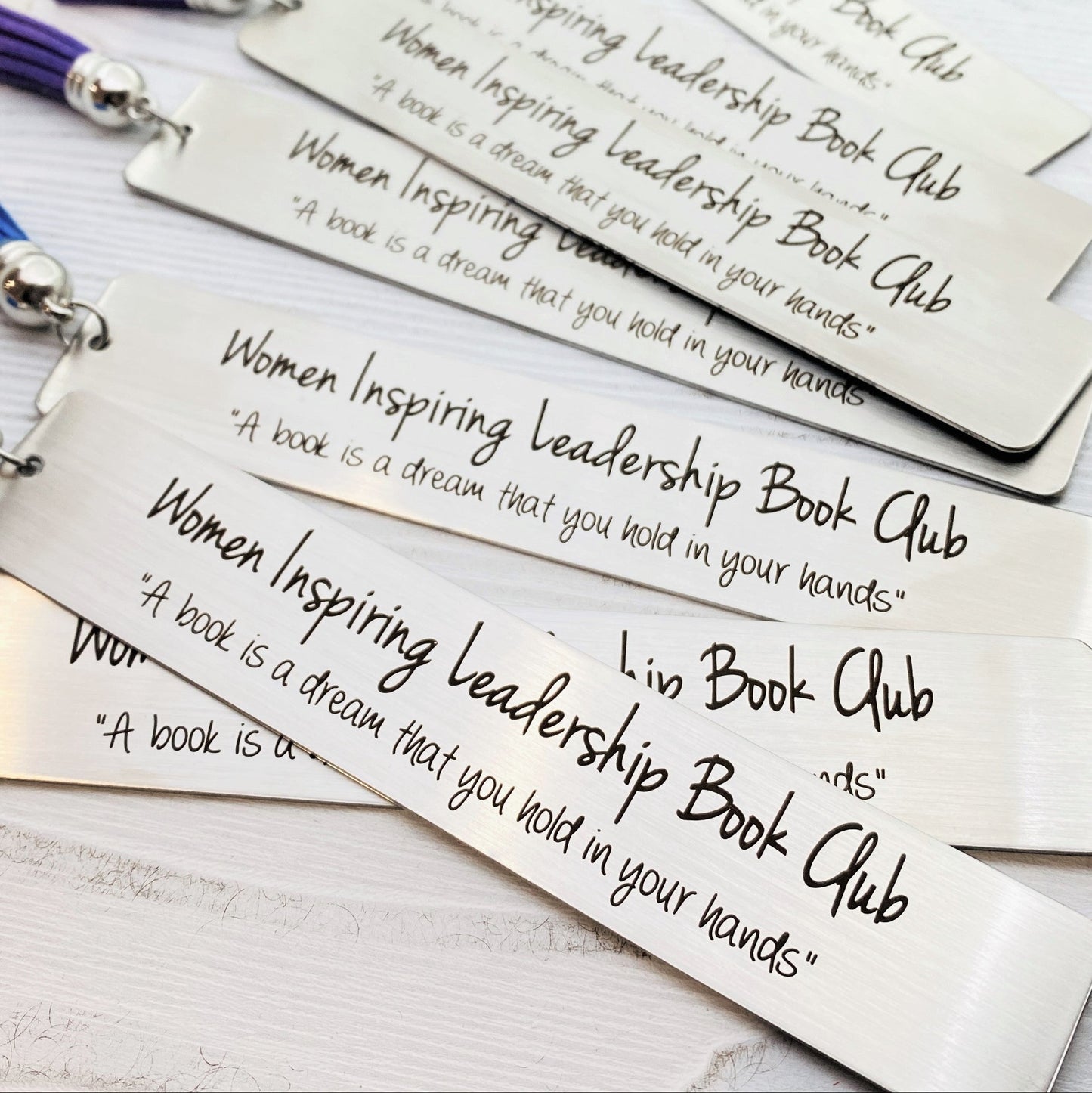 Personalized metal bookmark made from stainless steel and engraved with your custom quote, club name, or special message. Unique keepsake gift for book lovers, book clubs, graduation gifts, literary events, and reader appreciation.