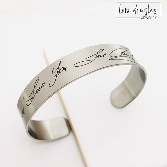 Personalized sympathy bracelet engraved with a father's handwritten signature. Stainless steel memorial cuff available in silver, gold, and rose gold as a remembrance gift for loss of Dad or a loved one.