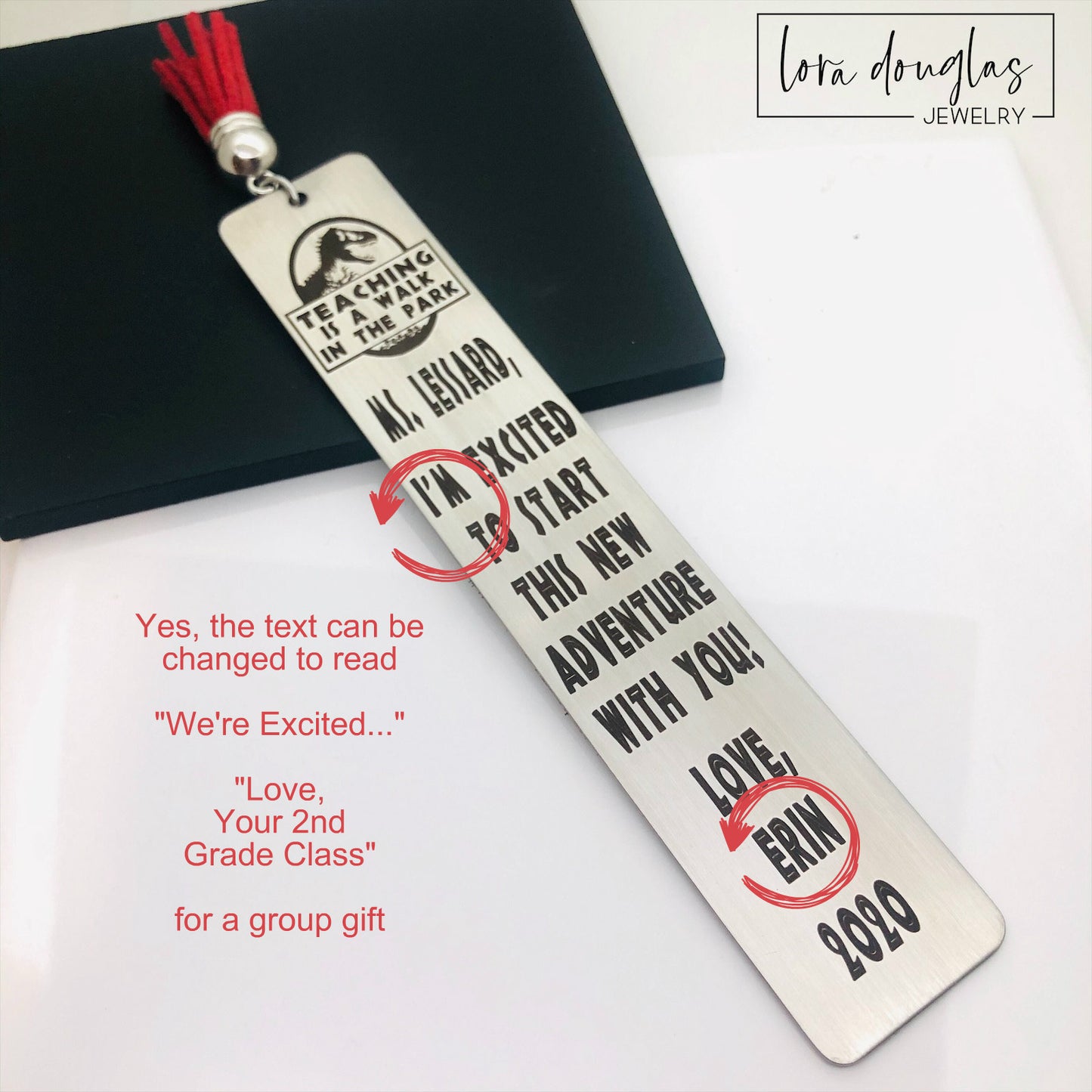 A stainless steel bookmark with an engraved message for a teacher, accompanied by a tassel and packaged for gift giving
