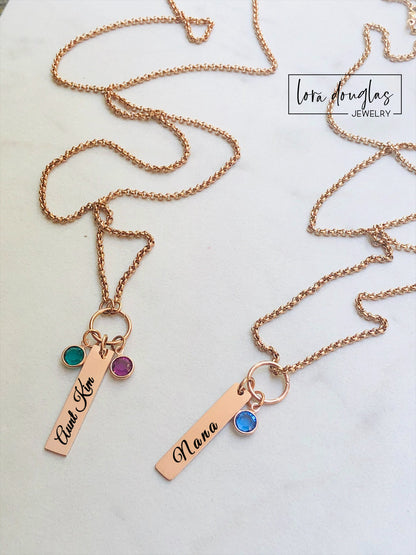 A rose gold birthstone necklace with a personalized engraving and a Swarovski Channel Plated Birthstone Charm.