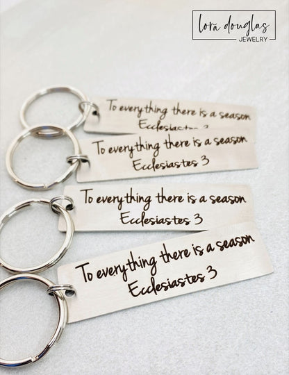 silver metal keychain with custom Bible verse engraved