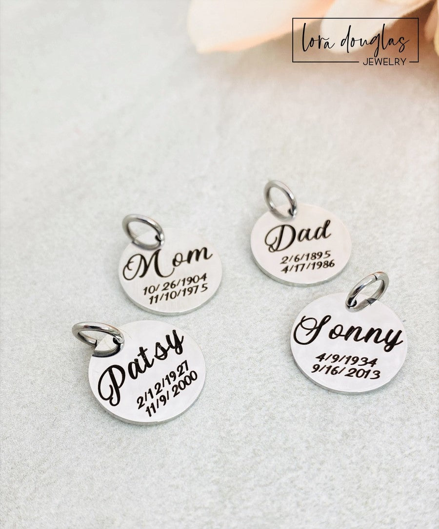 A collection of personalized jewelry items including necklaces, bracelets, and charms with engraved text and simple graphics on circular discs.