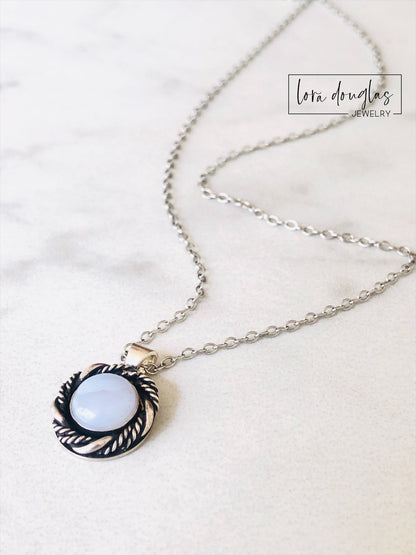 A sterling silver pendant necklace with a chalcedony stone set in a silver setting, attached to a sterling silver chain.